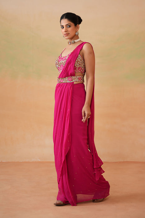 Fuchsia embroidered blouse, drape saree, belt