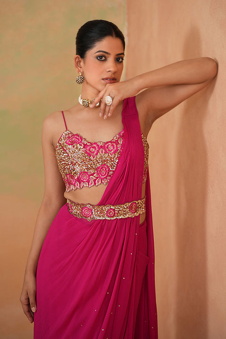 Fuchsia embroidered blouse, drape saree, belt