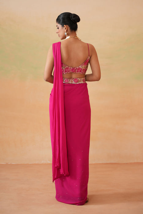 Fuchsia embroidered blouse, drape saree, belt